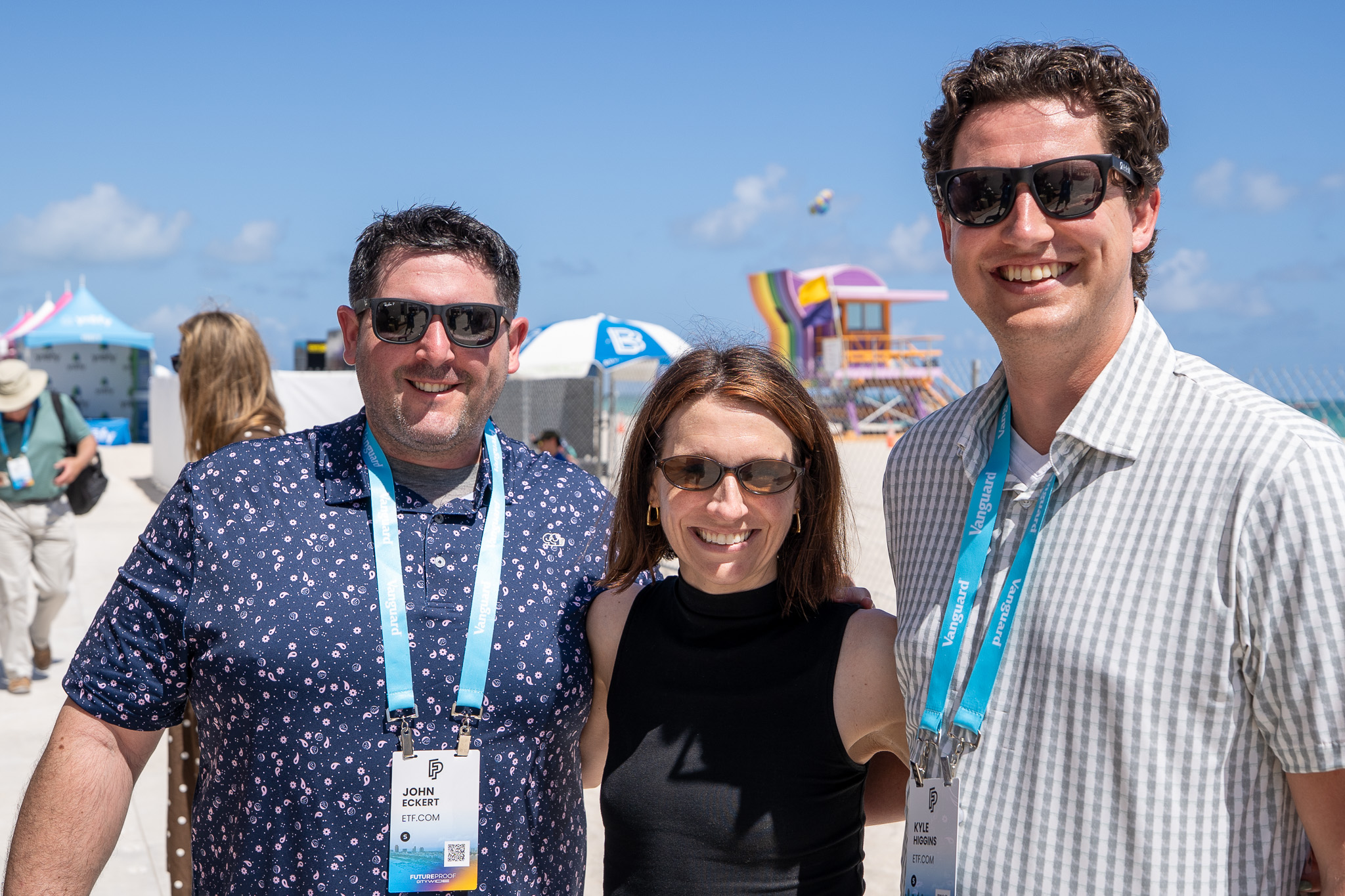 John Eckert, Courtney Phillips, and Kyle Higgins smile on the beach
