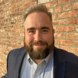 Conor MacWilliams, owner of Outer Beach Consultants, smiles into the camera