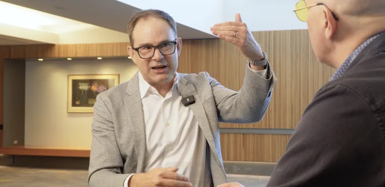 John West gestures while talking with Dave Nadig at Basis Northwest