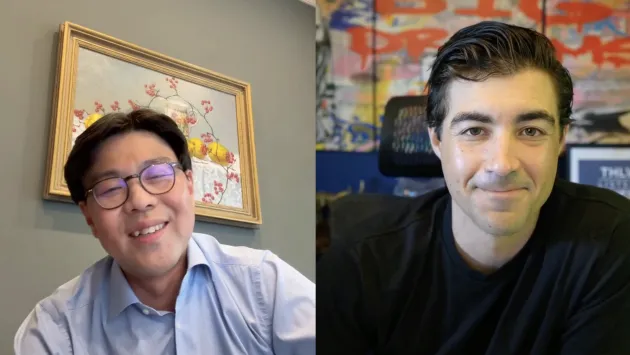Young Jae Lee and Brad Roth smile while talking