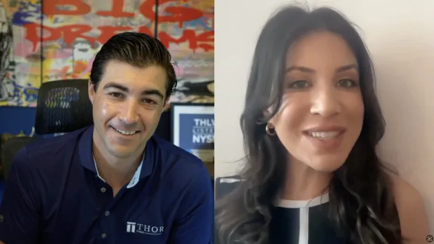 Eva Ados and Brad Roth smile while talking