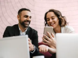 The Benefits of Vanguard's Core Bond and Core-Plus Bond Active ETFs People smiling at a phone