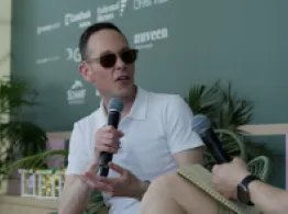 David Wright smiles while talking with Dave Nadig at the ETF Beach House