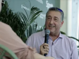 Barry Ritholtz smiles while talking on stage