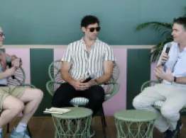 Dave Nadig, Chris Ward, and Corey Hoffstein discuss strategies on sitting in rattan chairs on stage. 
