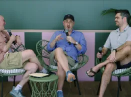 Brian Portnoy, Zach Conway, and Dave Nadig laugh while talking on stage.