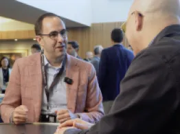 Why ETFs Are the Key to Bringing Wall Street On-Chain Alex Morris smiles while talking with Dave Nadig at Basis Northwest